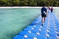 Relax time, tourists walking plastic pontoon to the beach Royalty Free Stock Photo