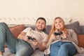 Happy couple holding joysticks and playing video game Royalty Free Stock Photo