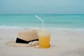 Relax on a tropical island, concept. Protection from sun and heat. Straw hat and pineapple juice. Royalty Free Stock Photo