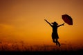 Relax Umbrella woman jumping and sunset silhouette Royalty Free Stock Photo
