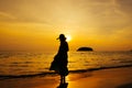 Relax Woman standing  on the beach  sea  Sunset silhouette Royalty Free Stock Photo