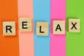 Relax word of wooden letters on a color striped background