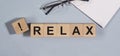 RELAX word written on wooden cube blocks on office table Royalty Free Stock Photo