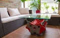 Relax zone in conservatory with table from engine and rattan sofa