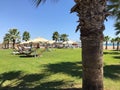 Relaxation area on the beach by the sea with beach umbrellas, sunbeds and tables for drinks