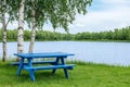 Relaxation area in the park, picnic table set in serene surroundings. Royalty Free Stock Photo