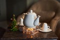 Relaxation area in the spa, drink tea, on the table there is a white teapot, in the background a Christmas tree