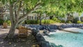 A relaxation area by the swimming pool with turquoise water. Royalty Free Stock Photo