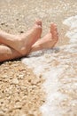Relaxation on beach, detail of male feet Royalty Free Stock Photo