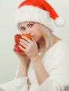 Woman in santa christmas hat drinking tea or coffee Royalty Free Stock Photo