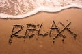 Relaxation Concept, Relax Word Written on Summer Sand Beach with Royalty Free Stock Photo