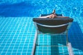 Relaxation Concept : Woman sleeping on outdoor daybed in swimming pool.