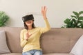 Relaxation concept, Young woman playing game and touching air to experience virtual with glasses VR