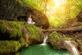 Relaxation in forest at the Waterfall. Ardha Padmasana pose