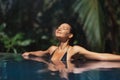 Summertime Bliss, Luxury Relaxation of Bikini Woman in Infinity Pool Royalty Free Stock Photo