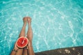 Relaxation and Leisure - Lifestyle in summer of Tanned girl holding watermelon Tropical fruit in the blue pool. Royalty Free Stock Photo