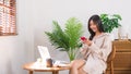 Relaxation lifestyle concept, Young Asian woman use smartphone to chatting after working at home Royalty Free Stock Photo