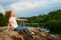 Relaxation, meditation mental health concept. National Relaxation Day. Red-haired woman meditates and relaxes in nature