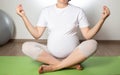 Relaxation and meditation for a pregnant girl on a fitball ball on a white background. Women Health