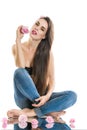 Relaxation, meditation. Young beautiful woman sitting on the floor in jeans. The girl holds a rose in hands.