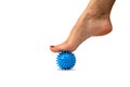 Relaxation of the muscles of the foot with a spiky silicone massage ball, physiotherapy at home. Relieve