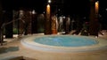 Relaxation pool in spa with waterfall. Empty luxury spa with jacuzzi and swimming pool. Jacuzzi in the sauna. Wellness Royalty Free Stock Photo