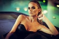 Relaxation and spa concept. Portrait of a sexy fashionable lady in a black swimsuit. Woman with wet hair and makeup Royalty Free Stock Photo
