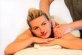 Woman laying on massage table and having a massage shoulders Royalty Free Stock Photo