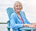 Relaxation starts now. Portrait of a happy senior woman relaxing on a chair outside. Royalty Free Stock Photo