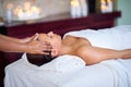 The relaxation station. a young woman receiving a head massage at a spa. Royalty Free Stock Photo