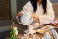 Relaxation and tea party in the spa, a girl in a bathrobe pours tea from a white teapot