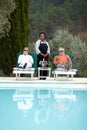 Relaxation on vacation. A senior couple enjoying champagne at the pool while on vacation. Royalty Free Stock Photo