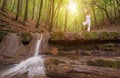 Relaxation, Woman practices yoga at the waterfall