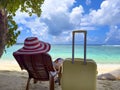 Relaxation young man lying on bed chair with Yellow of the luggage on the beach Royalty Free Stock Photo