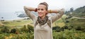 Relaxed adventure woman hiker in front of ocean view landscape Royalty Free Stock Photo