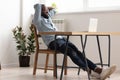 Relaxed african american businessman chilling in office room finished work Royalty Free Stock Photo