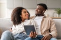 Relaxed african american couple wearing earbuds listening music together indoors Royalty Free Stock Photo