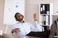 Relaxed african american man listening to music during working day Royalty Free Stock Photo