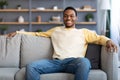 Relaxed african american man resting on sofa at home