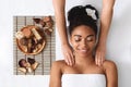 Relaxed african american woman enjoying body massage at spa Royalty Free Stock Photo