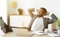 Relaxed african businessman enjoy listening music in earphones at workplace