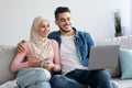Relaxed arab family watching movie on laptop Royalty Free Stock Photo