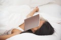 Relaxed Asian girl sleeping on her bed with a book Royalty Free Stock Photo