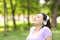 Relaxed asian woman listening to music in a park Royalty Free Stock Photo