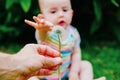 Relaxed baby enjoying the sensation of noticing the freshness of the grass on his bare feet