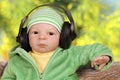 Relaxed Baby listening music in Park Royalty Free Stock Photo