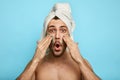 Relaxed bearded man applying a mask on his cheek Royalty Free Stock Photo