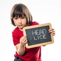 Relaxed beautiful little child with school slate against head lice Royalty Free Stock Photo