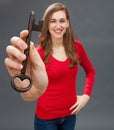 Relaxed beautiful woman holding big key as symbol of success