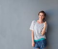 Relaxed beautiful woman smiling against gray background